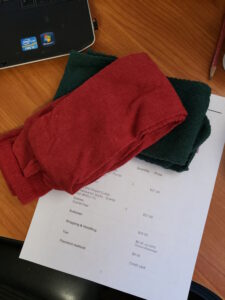 red socks and green socks sitting on an order sheet