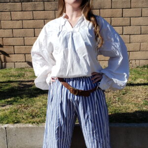 the She Devil of the Sea poses wearing blue and white striped pirate breeches